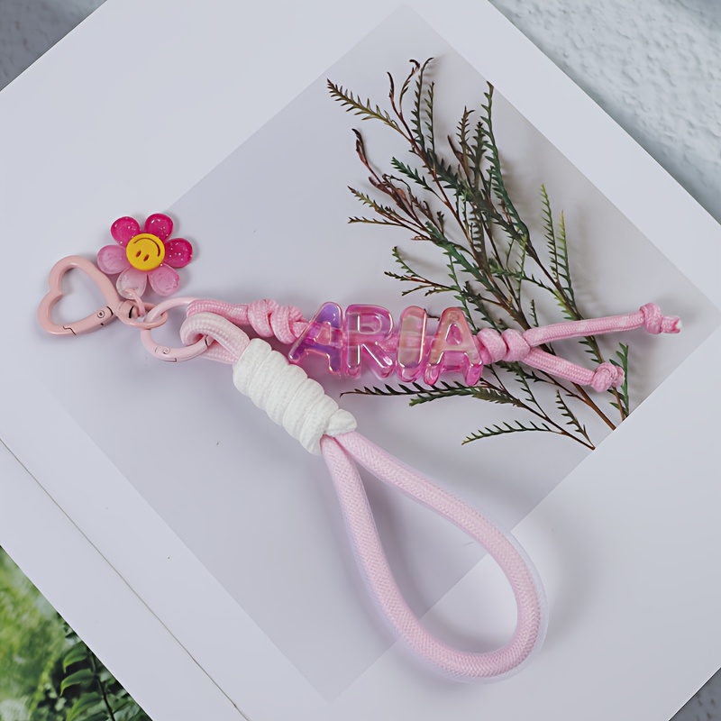 TEMU A Cute Floral Letter Knot Custom Keychain, Of A Lanyard, Letter Beads, And Transparent Flowers. Available In Multiple Colors. Custom Letters,