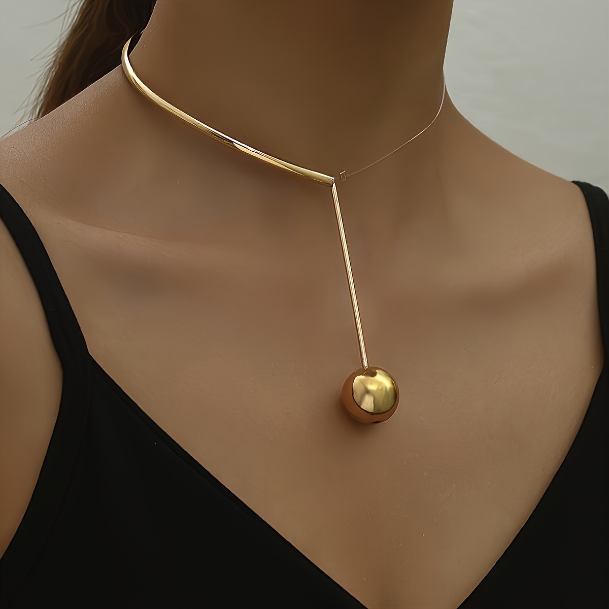 

A Stylish Half-transparent/golden Necklace With A Spherical Pendant, Dates And Parties.