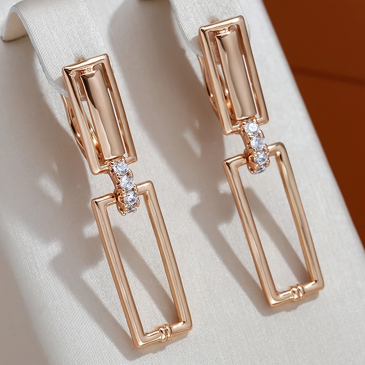 Image of A Pair Of Classic Elegant Synthetic Synthetic Zirconia Golden Earrings Suitable For Birthday Parties