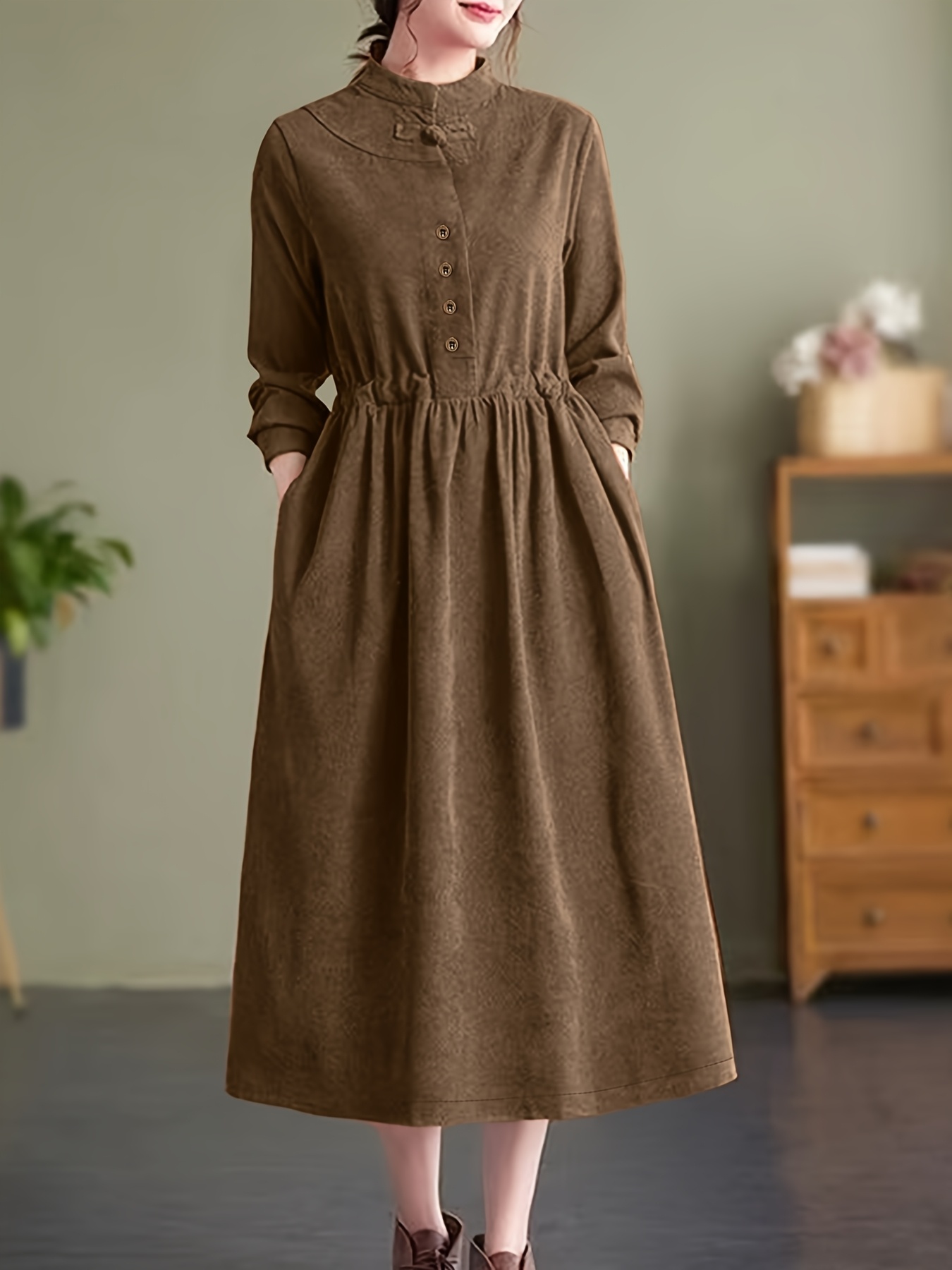 Model wearing a stunning retro Chinese style maxi dress in soft polyester featuring a stand collar button detailing and long sleeves Perfect for autumnwinter