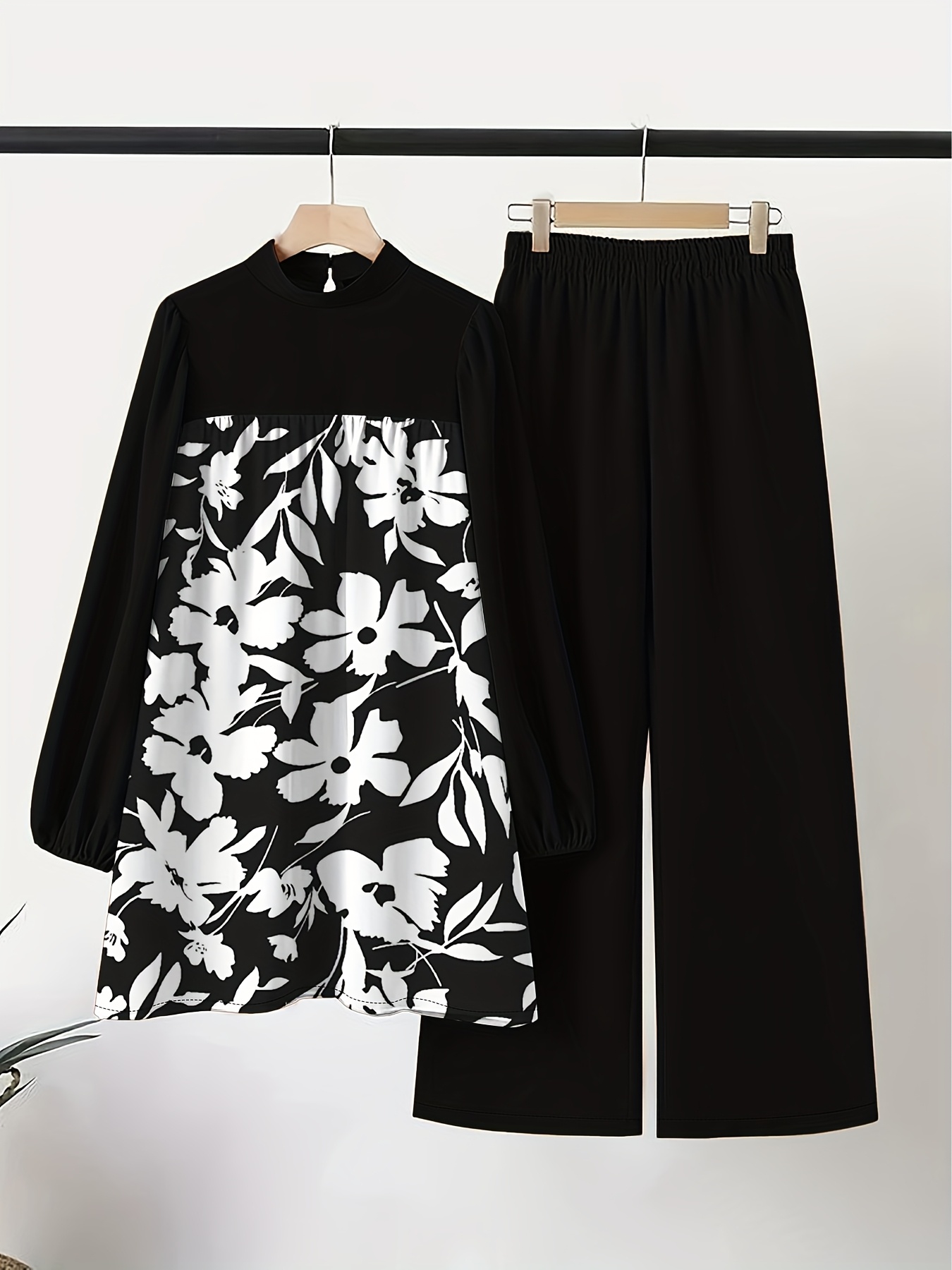 Model wearing Newness Secret Garden floral print pantsuit a chic and sophisticated pantsuit featuring a vibrant floral print The pantsuit is perfect for both professional and special occasions