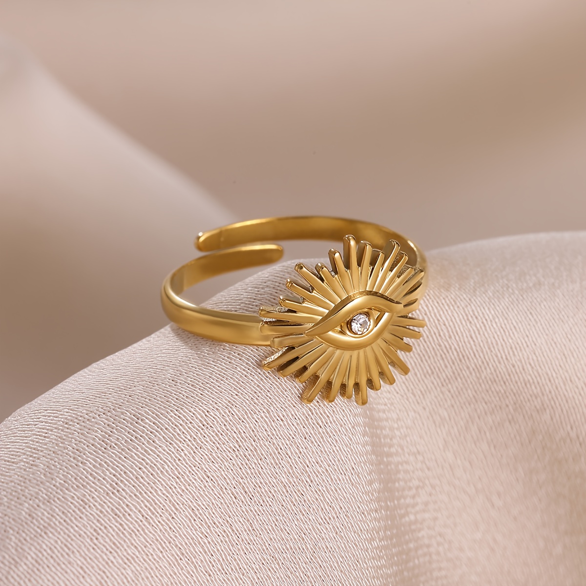 A Golden-colored Stainless Steel Tiny Ring Featuring A Zirconia Stone In Of A Eye, A Stylish And Unique Jewelry Gift For Women