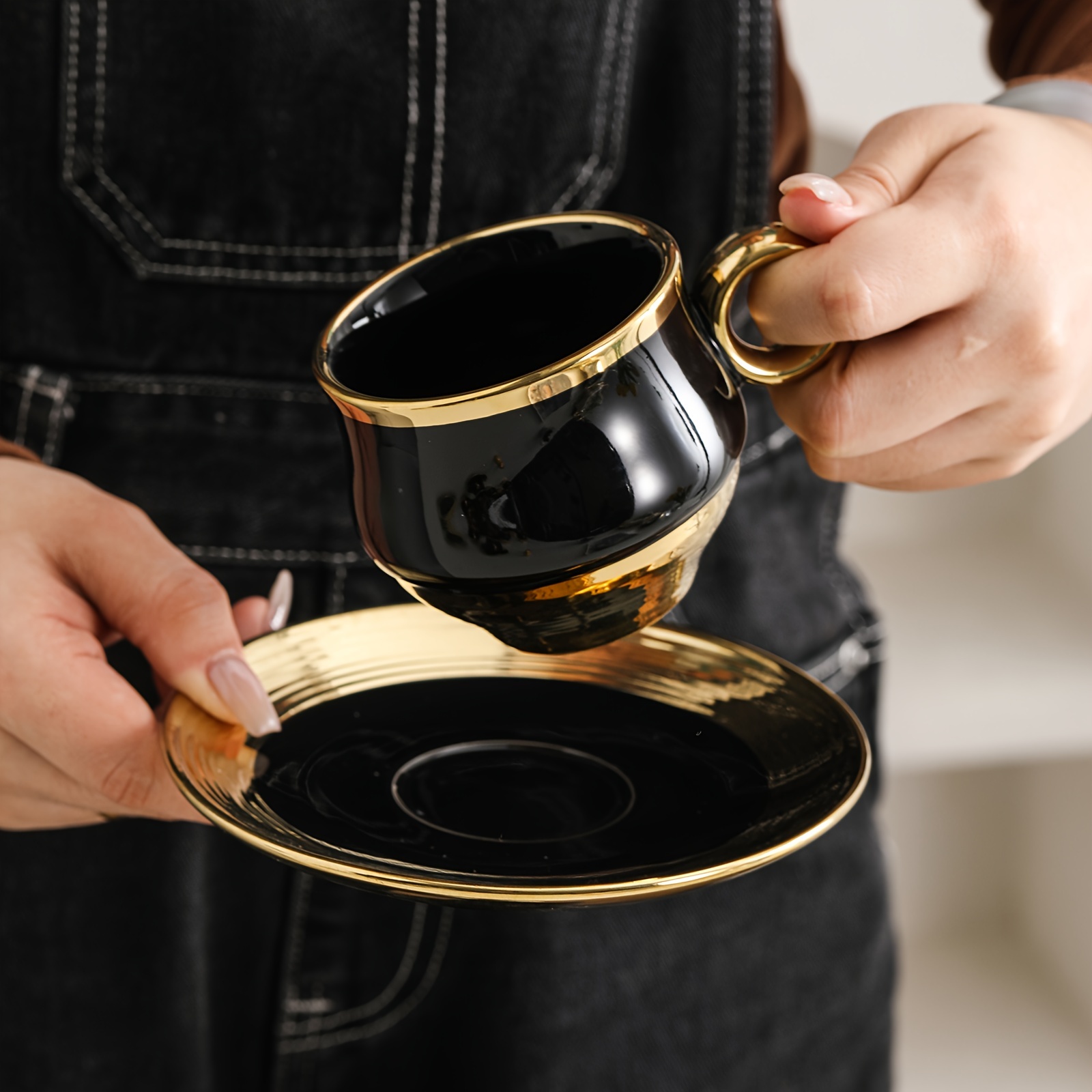 elegant gold trimmed black ceramic coffee cup and saucer set hand wash only bpa free microwave safe insulated easter theme reusable graphic pattern oval shaped multipurpose use for cold beverages ideal for adults luxury business gift 6 cups 6 saucers 150ml 5 29oz details 7
