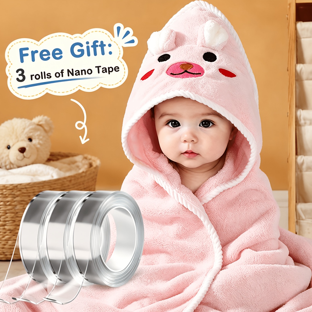 Pink hooded baby bath towel shown wrapped around a baby