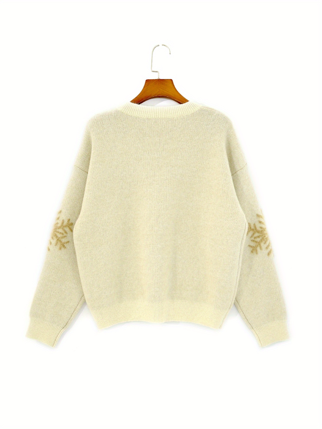 Close up of the round neck sweater showing the apricot color and knit texture