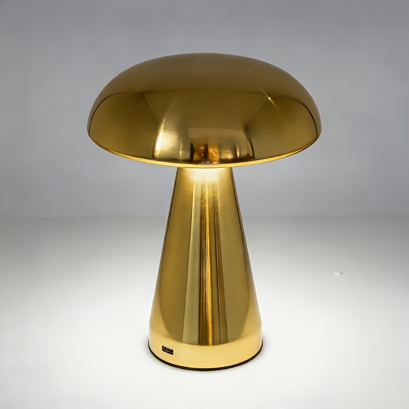 Gold-tone mushroom-shaped table lamp switched on
