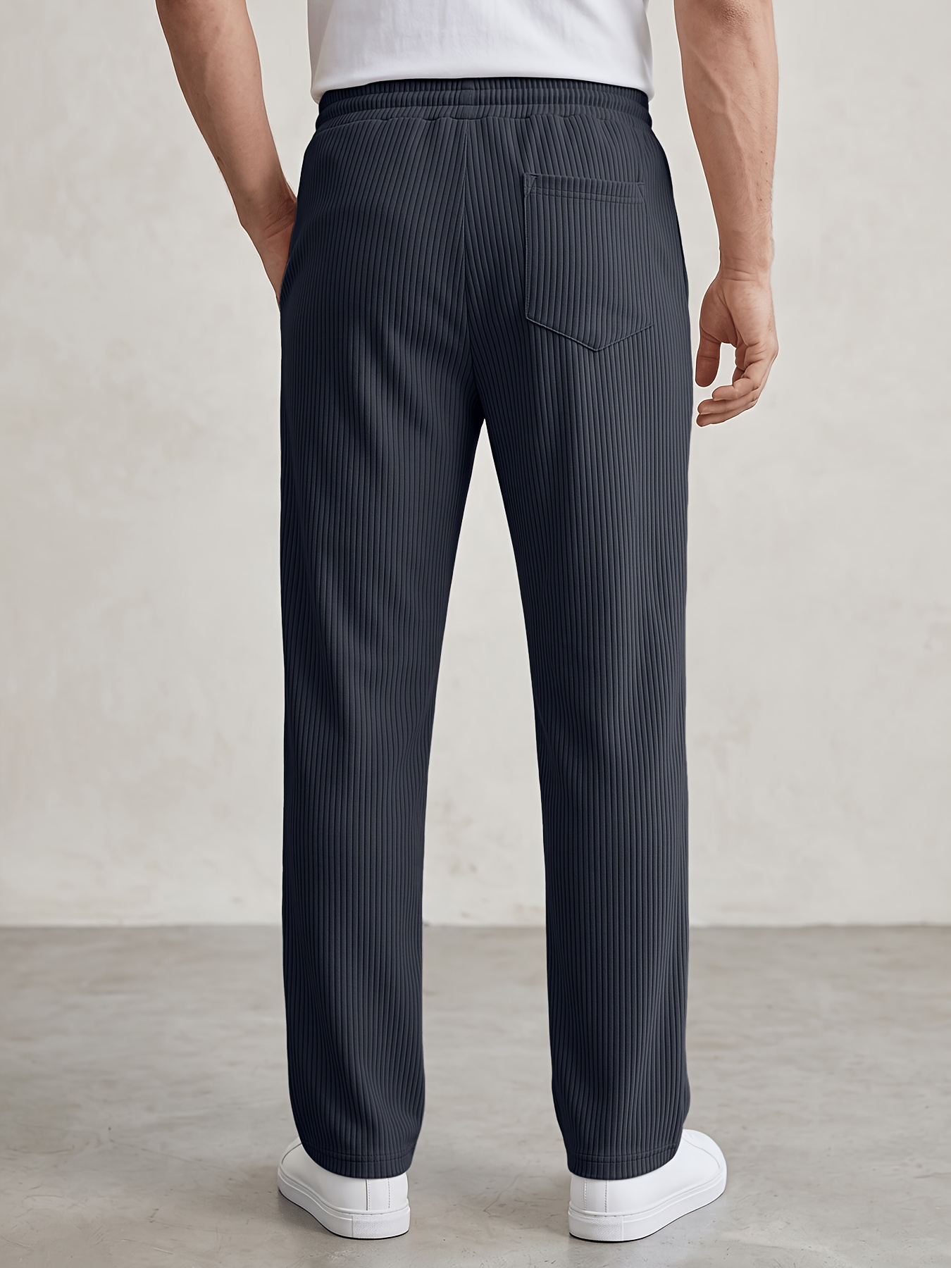mens straight leg sweatpants with     and vertical stripes featuring an elastic drawstring waist side pockets and a loose wide   made from lightweight cooling fiber fabric with a textured feel   solid colored pants are