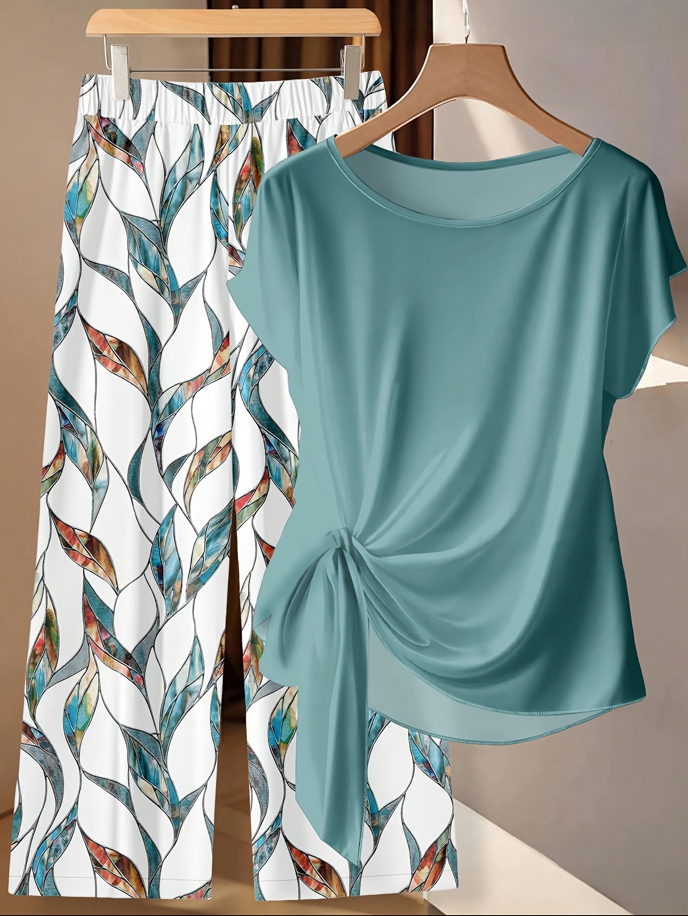 A Two-Piece Women'S Casual Minimalist Outfit Featuring a Green Bow Tie Shirt And Loose Straight Geometric Print Pants, Perfect for Early Autumn