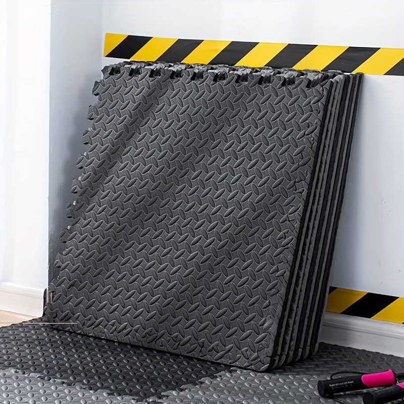 A gym flooring mat stacked against the wall