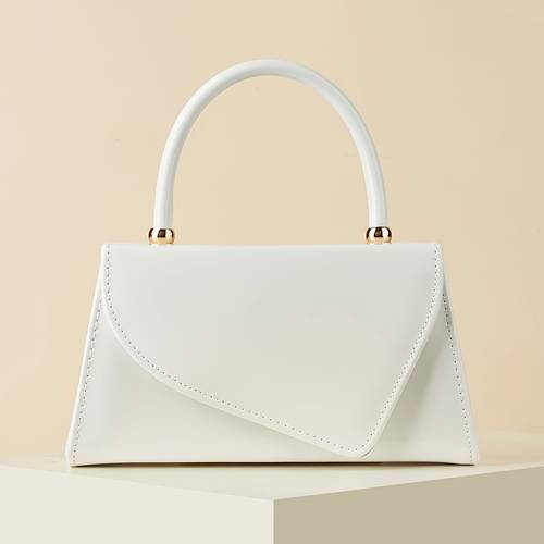 a stylish handbag for of smooth leather in a single color featuring an asymmetrical flap design beautiful and minimalist