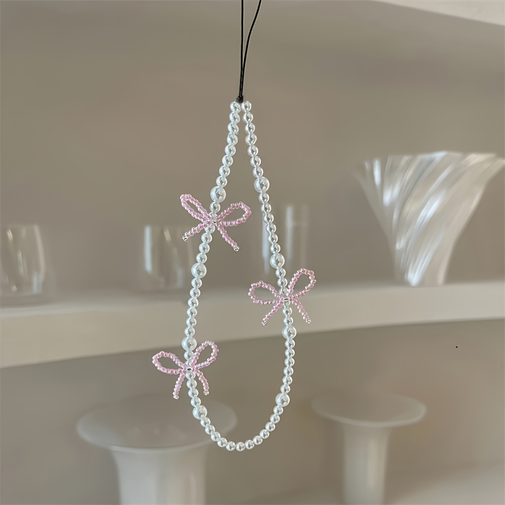 

Bracelet de charme en perle rose avec nœud - Design à 3 nœuds - Accessoire pour étui de téléphone - Matériau en plastique