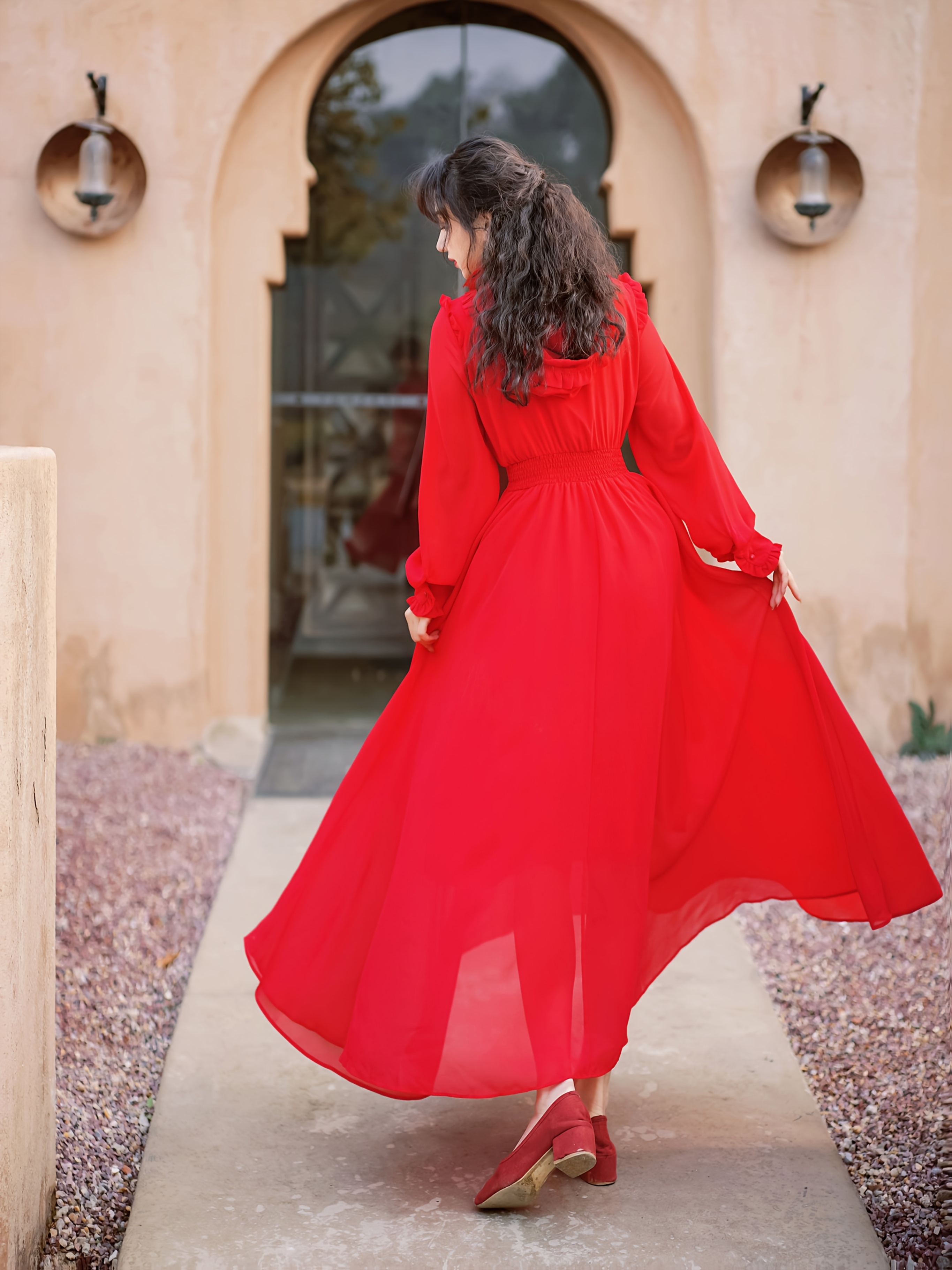 red dress desert Beautiful Woman in Red Dress in Arabic Desert. Stock Photo