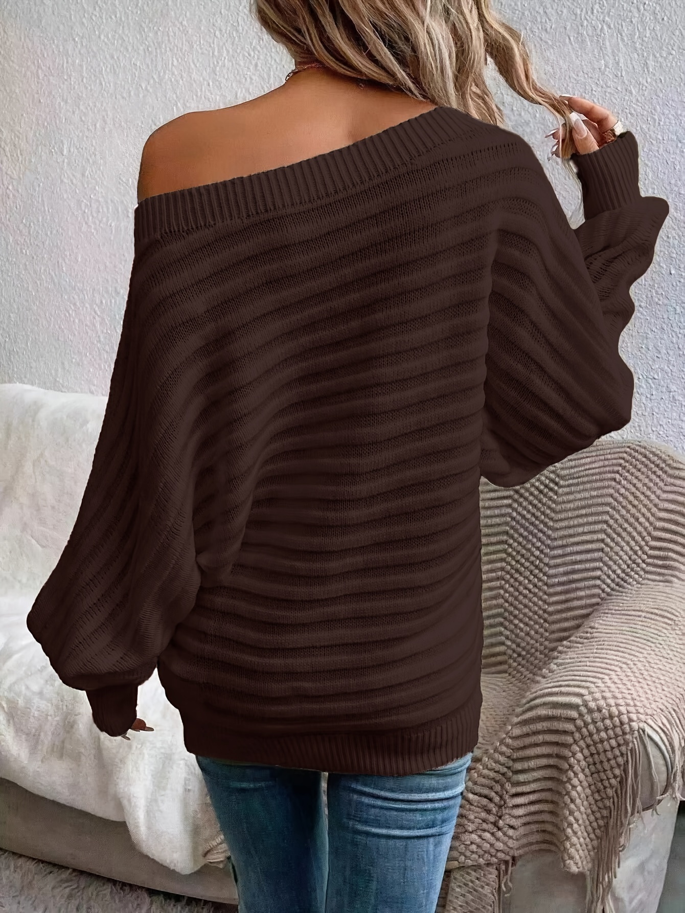 The back view of a women's off the shoulder sweater sold by 100 Spartans