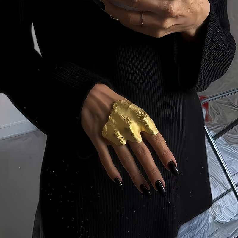 A Matte Golden Irregular Pleated Texture Wide Double-finger Ring, Featuring A With An Unconventional Joint. This Elegant And Piece Is And Parties, Making It An Ideal Gift For Birthdays