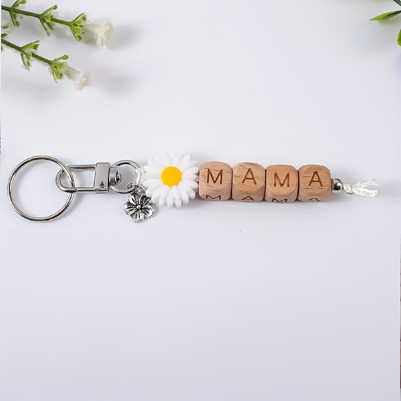 E-shop Ein stilvoller und minimalistischer Anhänger mit perlenbesetztem Blumenmuster, als Taschenaccessoire, um Schlüssel zu vermeiden, ideal als