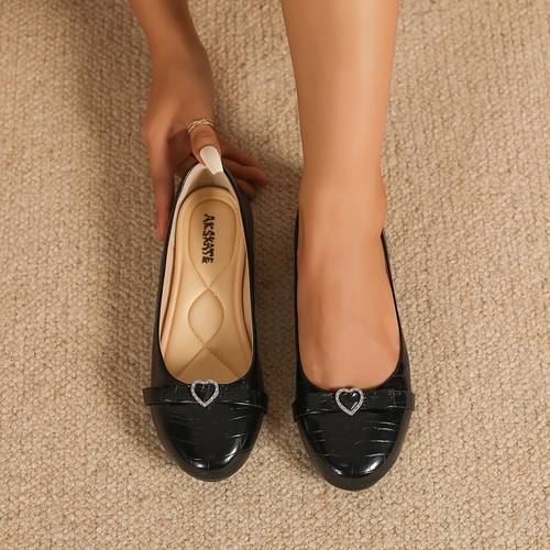 a pair of heart shaped studded womens flat shoes comfortable and fashionable suitable for indoor and outdoor with multiple colors from