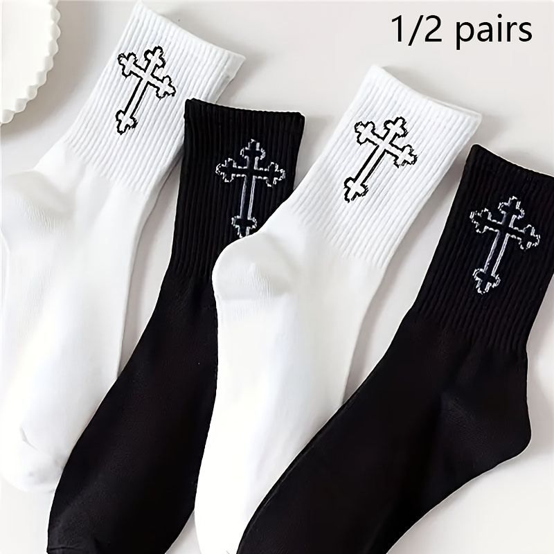 a set of black and white   calf socks suitable for   men and women stylish and   solid color socks featuring a cross pattern designed to   moisture prevent slipping and provide    
