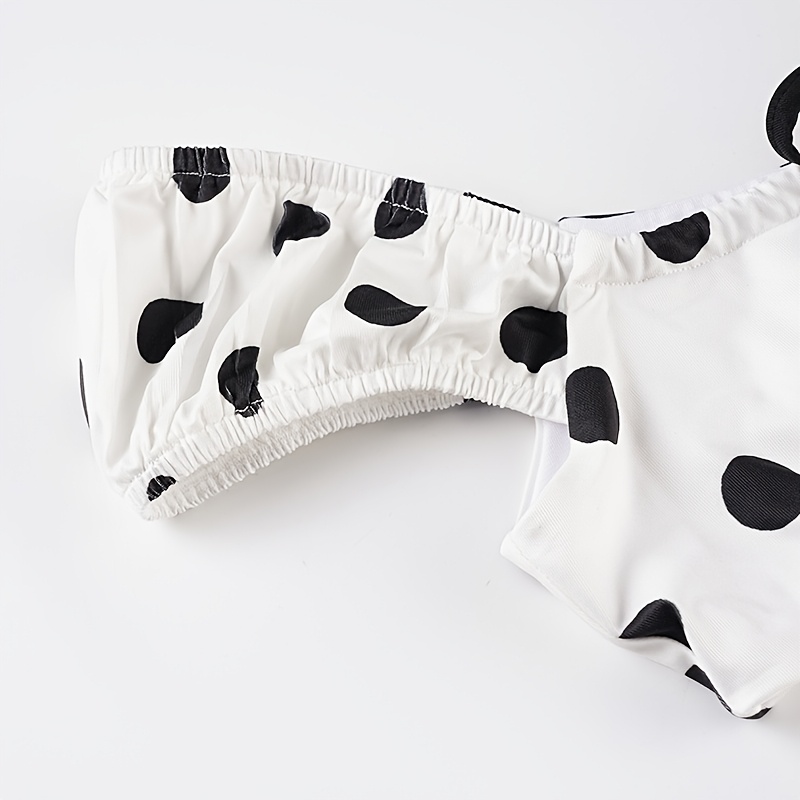 A Beach Vacation Outfit Featuring a Color-Blocked Polka Dot Bikini Set, with a Sexy Tie-Front Crop Top And Ruffled Shorts, Perfect for Seaside Holidays