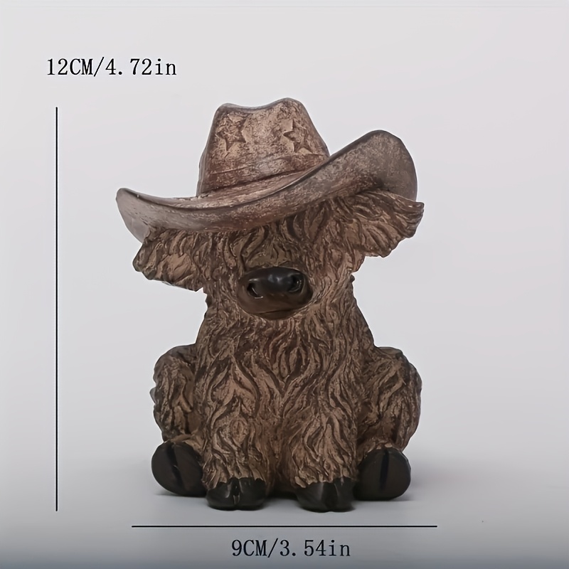 Image of A Resin Statue Of A Highland Cow - Featuring An Elegant Seated Gentleman Cow Design, Complete With A Cowboy Hat. This Piece Is Suitable For Farmhouse Decor, Gardening Displays