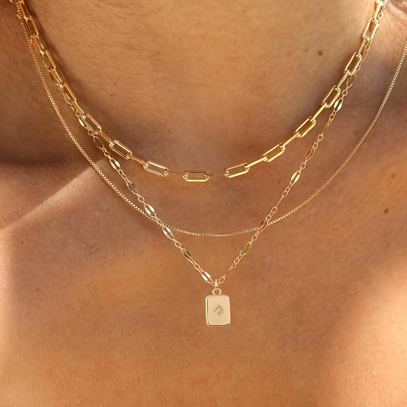 A Set of Three Original Trendy Checkered Paperclip Boxes with a Sparkling Cubic Zirconia Rectangular Pendant Necklace.