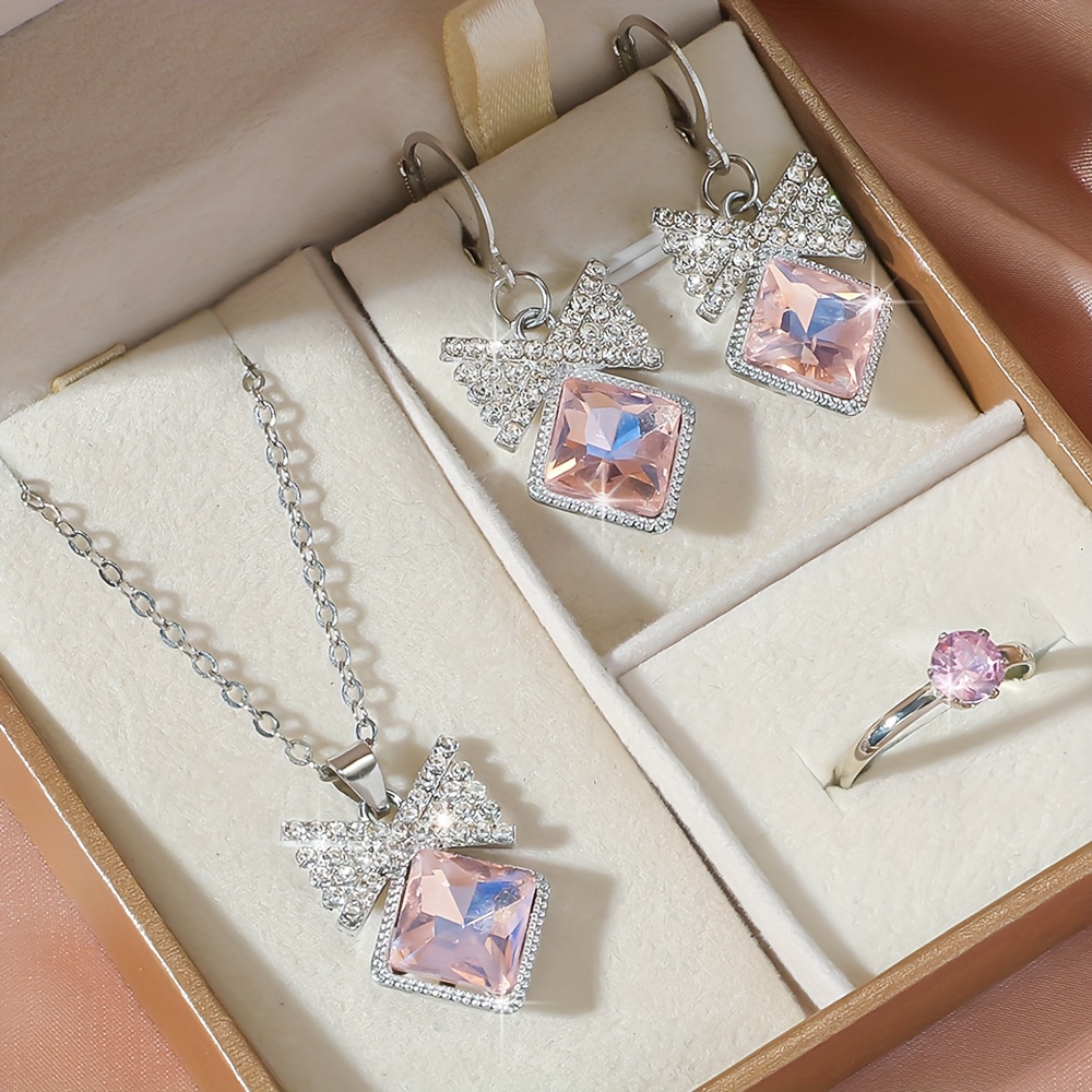 E-shop Set mit 4 Stück stilvolle Damen Schmuckstücke mit rosa Schleife, inklusive Anhänger-Halskette, Ohrringen und Ring, geeignet für den täglichen
