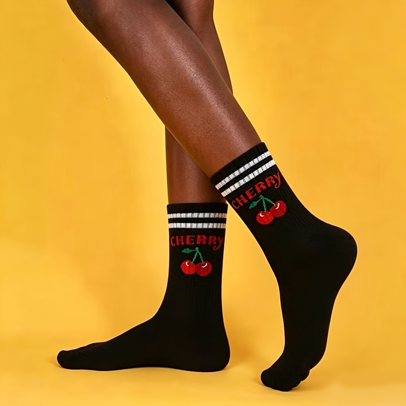 A Pair Of Black And White Sports Socks With Cherry Design For Women