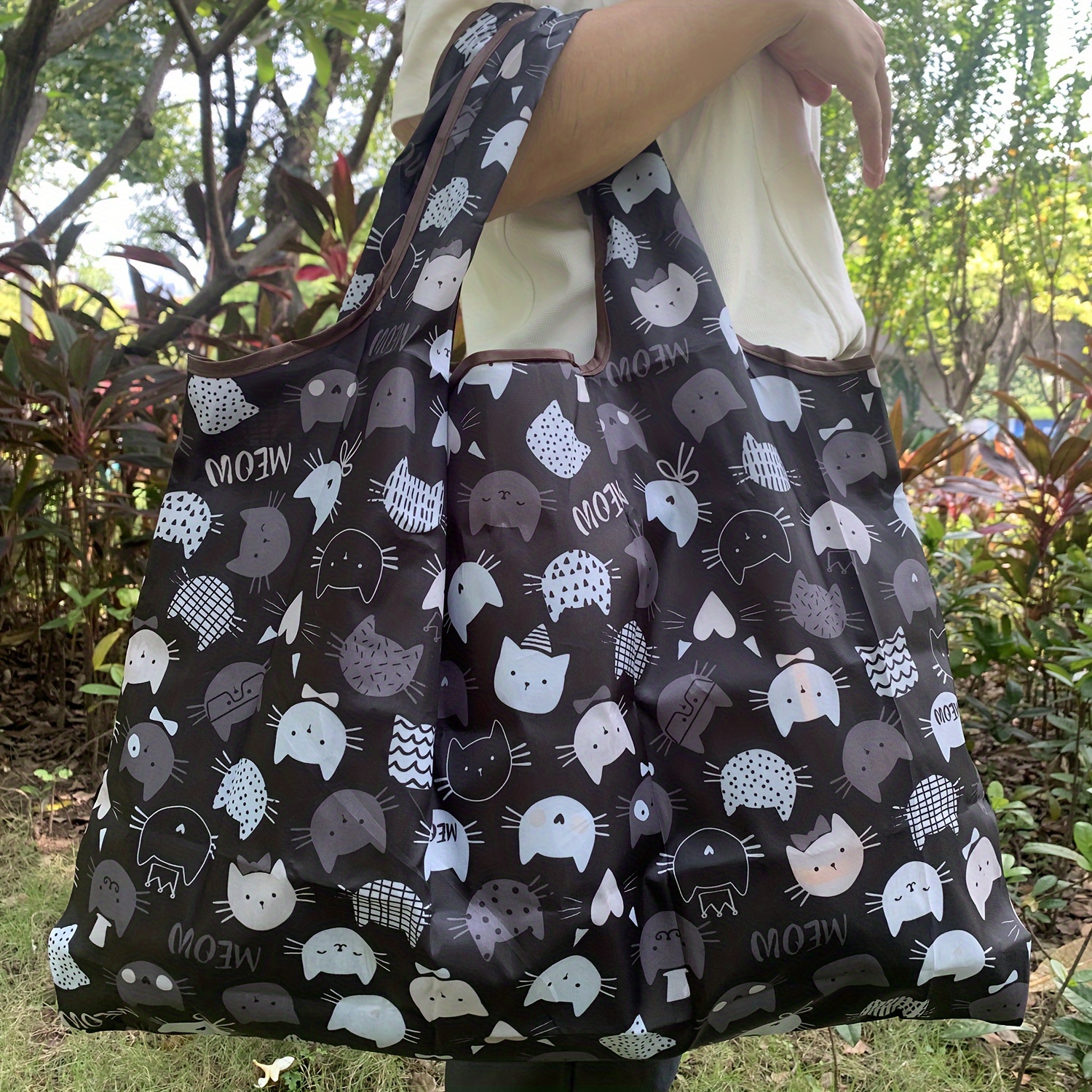 Image of Large Capacity Cute Cat Folding Shopping Bag - Durable Nylon Tote With Wrist Strap, Reusable & High-quality, Black & White Cartoon For Travel, Supermarket, And Use