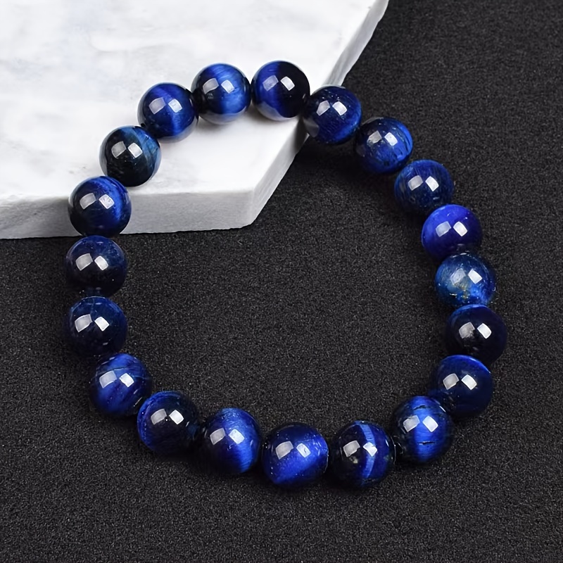 Custom Designed Tiger's Eye gemstone in Blue Paracord Bracelet by VLGL.  Email us at VL**@***** to let us help you d…
