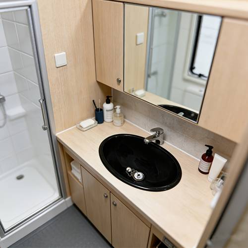 the rv bathroom sink is an oval shaped basin in black and white plastic a universal accessory suitable for rvs yachts and more