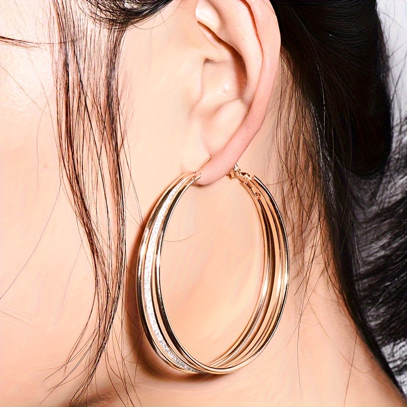 

A Pair Of Multi-layered Matte Big Hoop Earrings For Women, Featuring Exaggerated And Unique Ear Decorations.