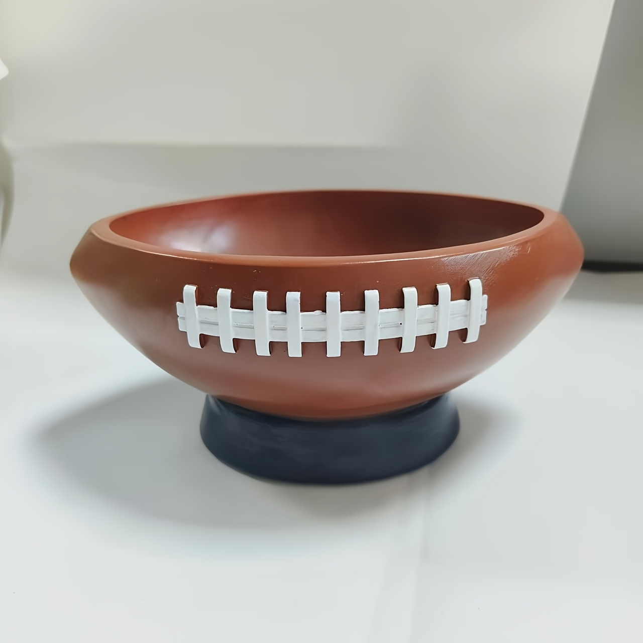 Image of A Creatively Designed Resin Statue In Of A Football, Perfect For Storing Items Room. This Decorative Storage Box Is Ideal For Home Entrances, Office Desks