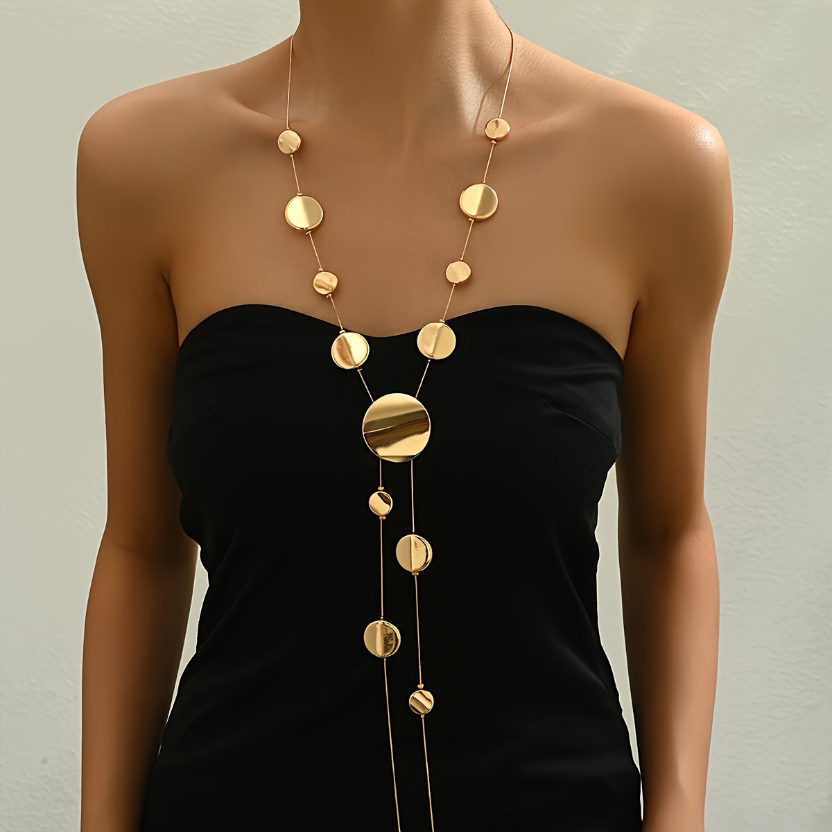 

A Stylish Long Golden Geometric Round Smooth Flat Bead Y-shaped Snake Chain Necklace.