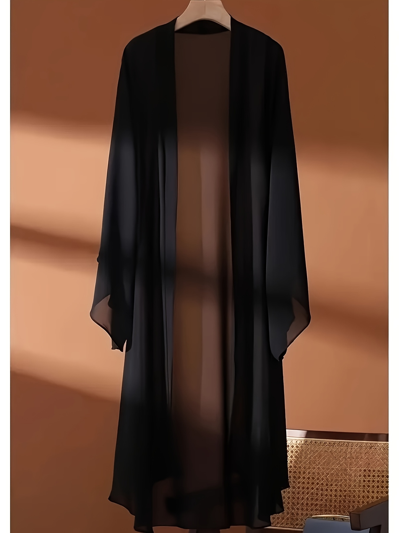 a bohemian style long sleeved cardigan suitable for wearing   summer and autumn in solid color with semi transparent and kimono style tops in white black and red the fabric is non elastic and   used as an outerwear for swimsuits
