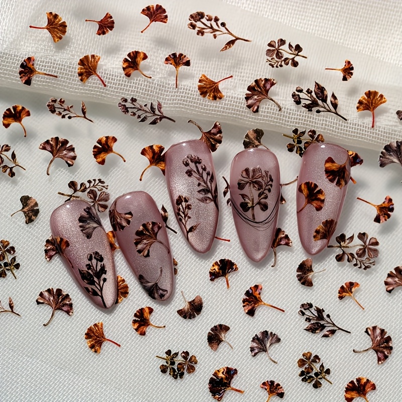 Image of A Vintage Nail Art Sticker Featuring Embossed Laser , Showcasing With Shapes Of Dark Ginkgo Leaves, Suitable For Personal And Nail Salons