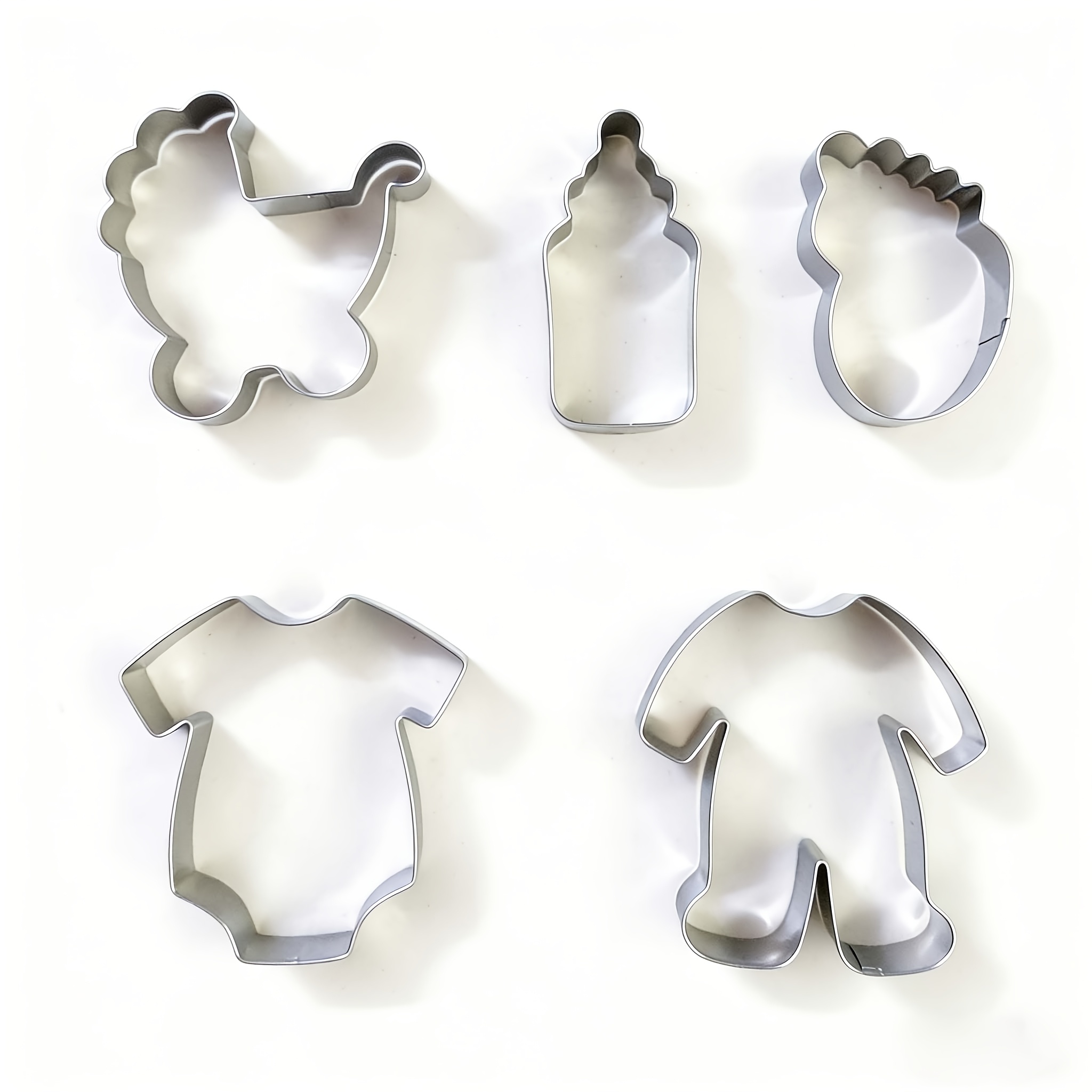 A 5pcs Baking Cookie Cutter Set Featuring Shapes Bottle, Clothes, A Onesie, A Stroller, And Footprints, Perfect For Birthday Parties