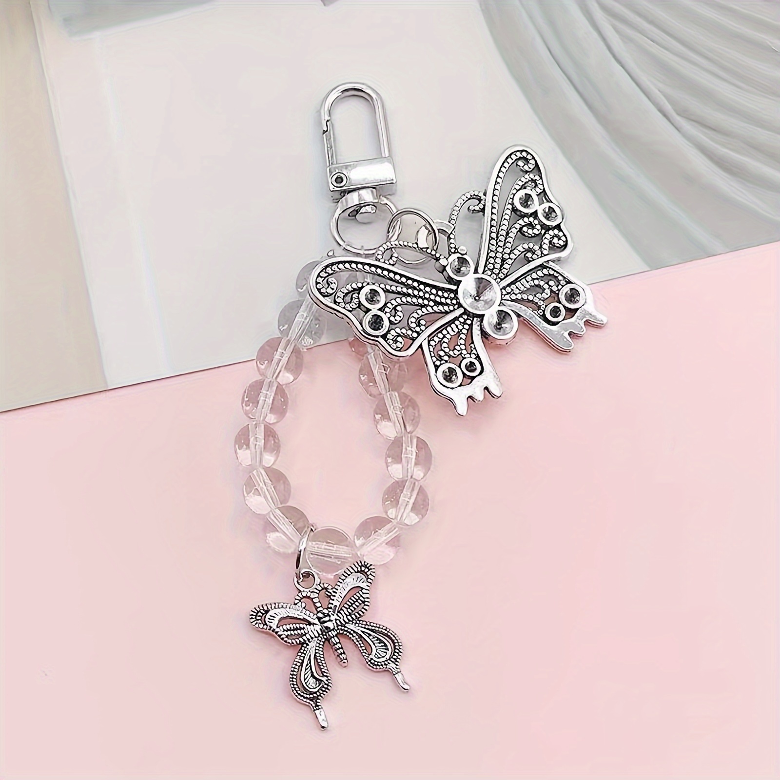 Image of A Silvery Phone Charm With Golden Accents, Transparent Beads, Keychain, Earphone Holder, And Diy Phone Case Accessory. Used As A Universal Clothing Decoration Pendant.