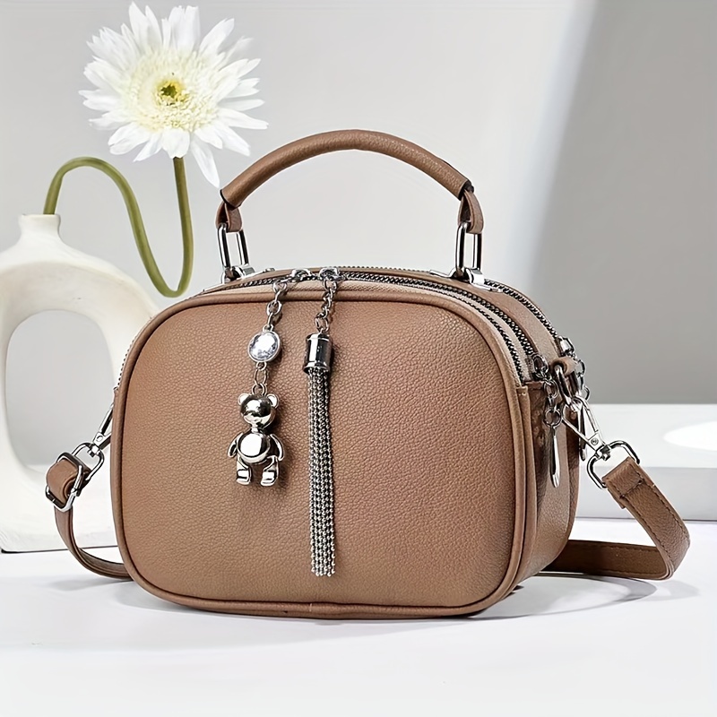 

A Stylish Solid Shoulder Crossbody Bag Made Of, Featuring A Cute Bear Tassel Design. With Multiple Compartments, Commuting, Travel, And . A Great Birthday Gift , Colleagues, Or .