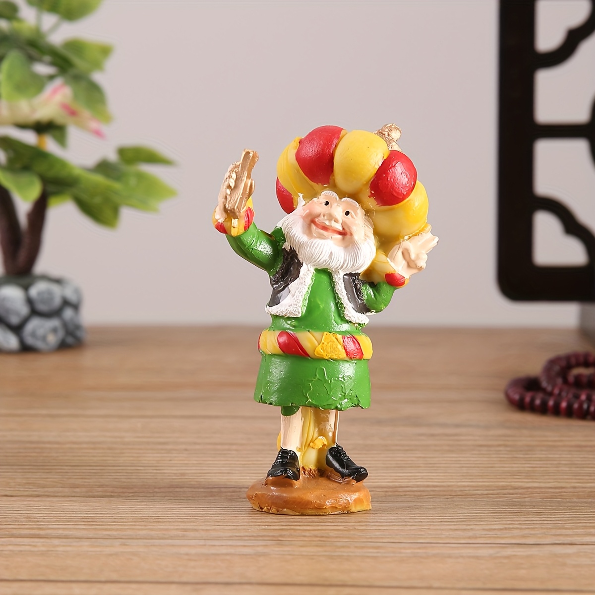 a resin figure of a chubby old man with a cannon suitable for decoration during eid celebrations Product details 1