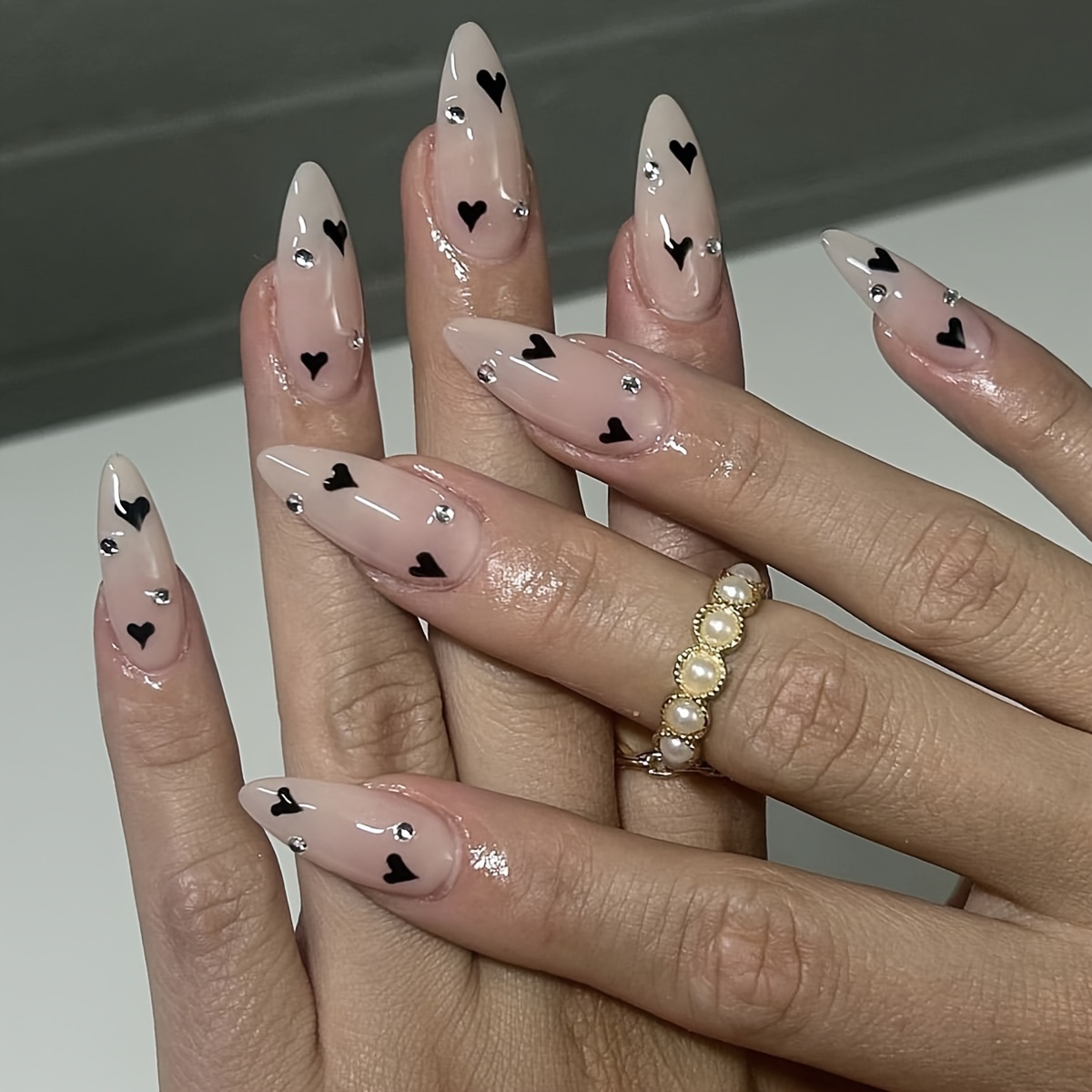 Image of 24pcs Almond Nails Nude Black Heart With Rhinestone Trim Design Fully Covered With Acrylic Removable Fake Nails For Women And