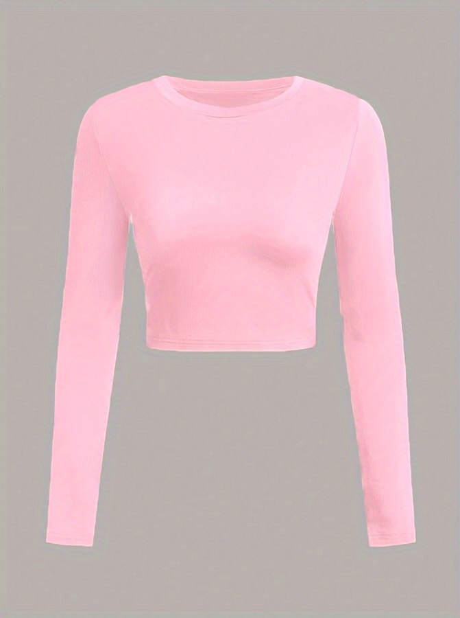 A pink women's long sleeve crop top sold by 100 Spartans