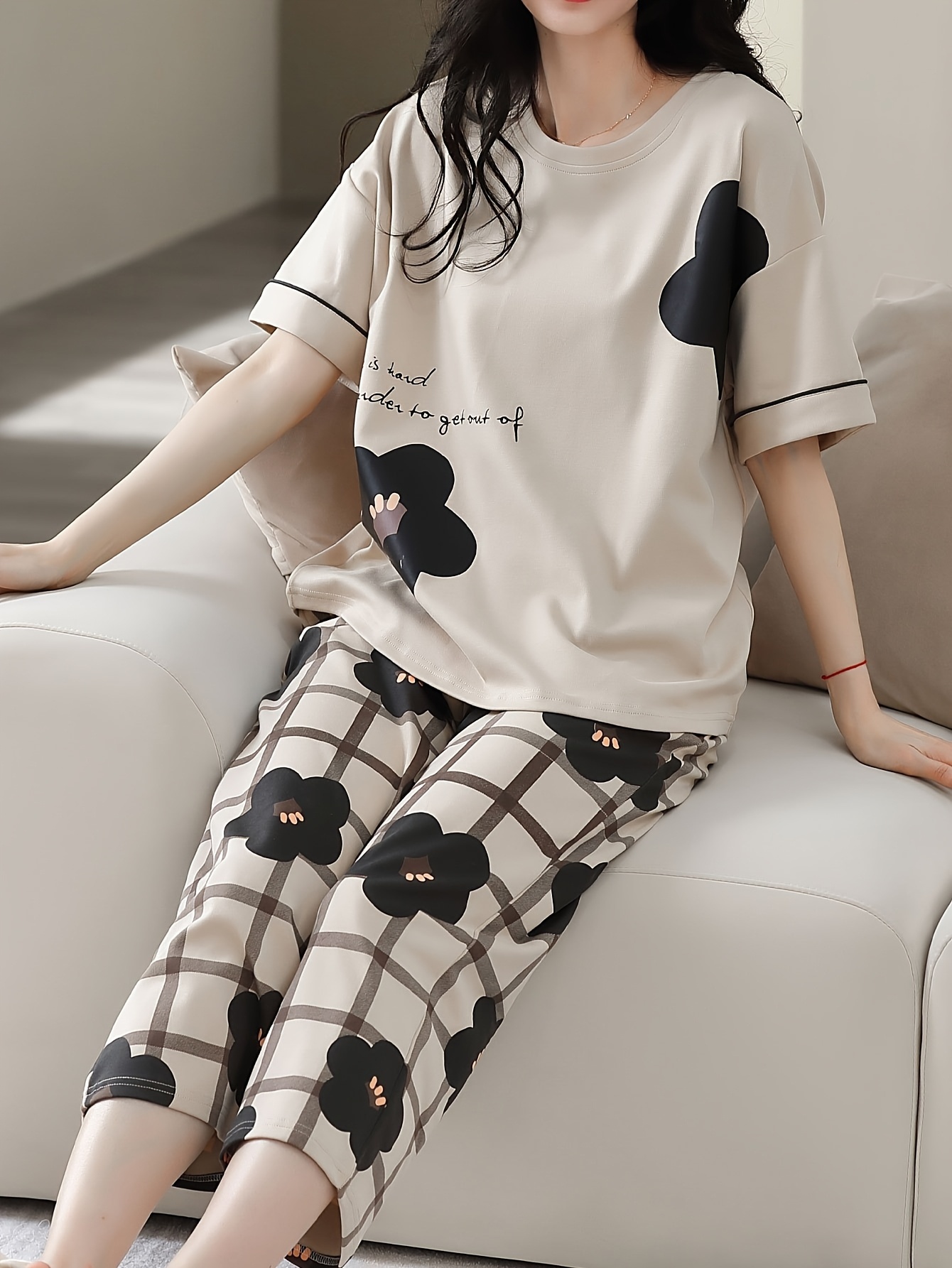 a set of womens summer fashion   wear featuring an elegant and   with floral print design including a round neck top and cropped pants pajama set