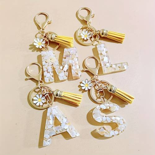 a beige a z stylish resin initial keychain with a cute daisy and tassel perfect as a backpack accessory or charm ideal for events and party gifts suitable for everyday use by women and as for friends