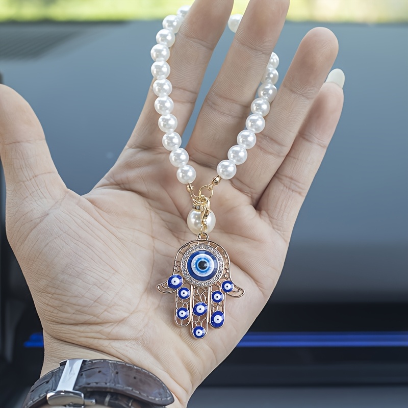 A Decorative Pendant For The Car Featuring A