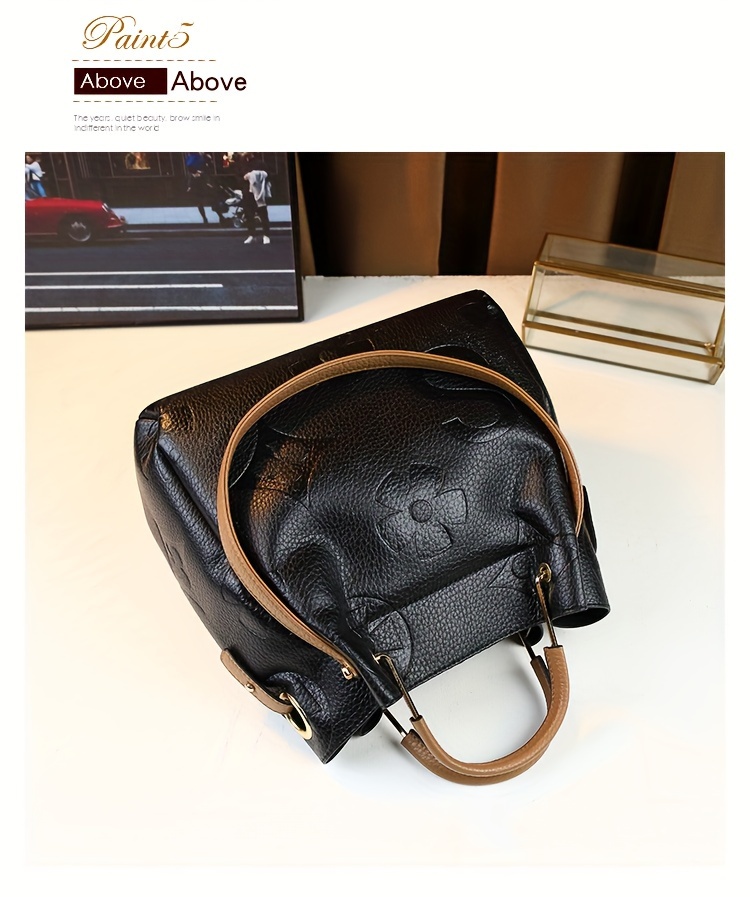 Black handbag carried on model's forearm