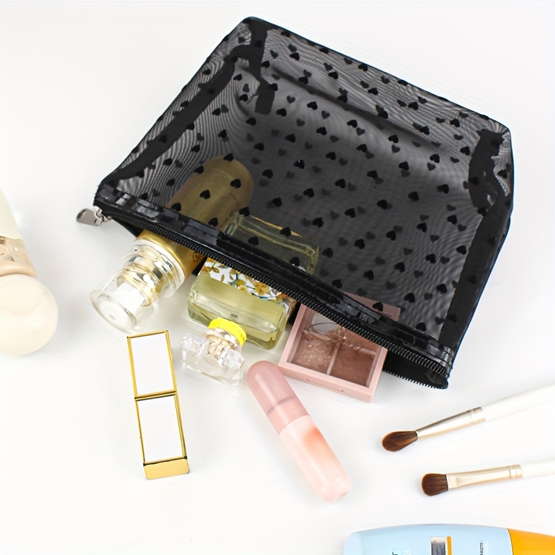 

A Stylish Mesh Heart-shaped Makeup Bag, Carrying Cosmetics And Toiletries While Traveling.