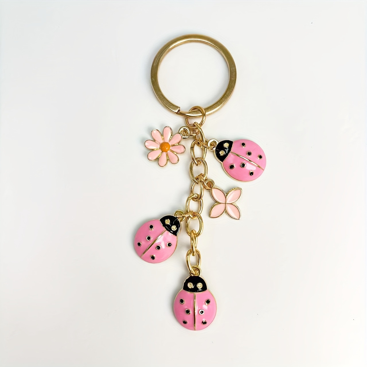 Image of Pink Hollow Ladybug & Daisy Clover Keychain - Golden Metal Fiber, Perfect For Bags & Gifts Suitable For Men And Women.