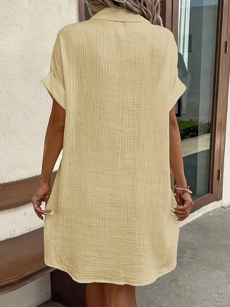 a minimalist white shirt dress made of breathable featuring a sharp collar design and buttons that add a touch of details 6