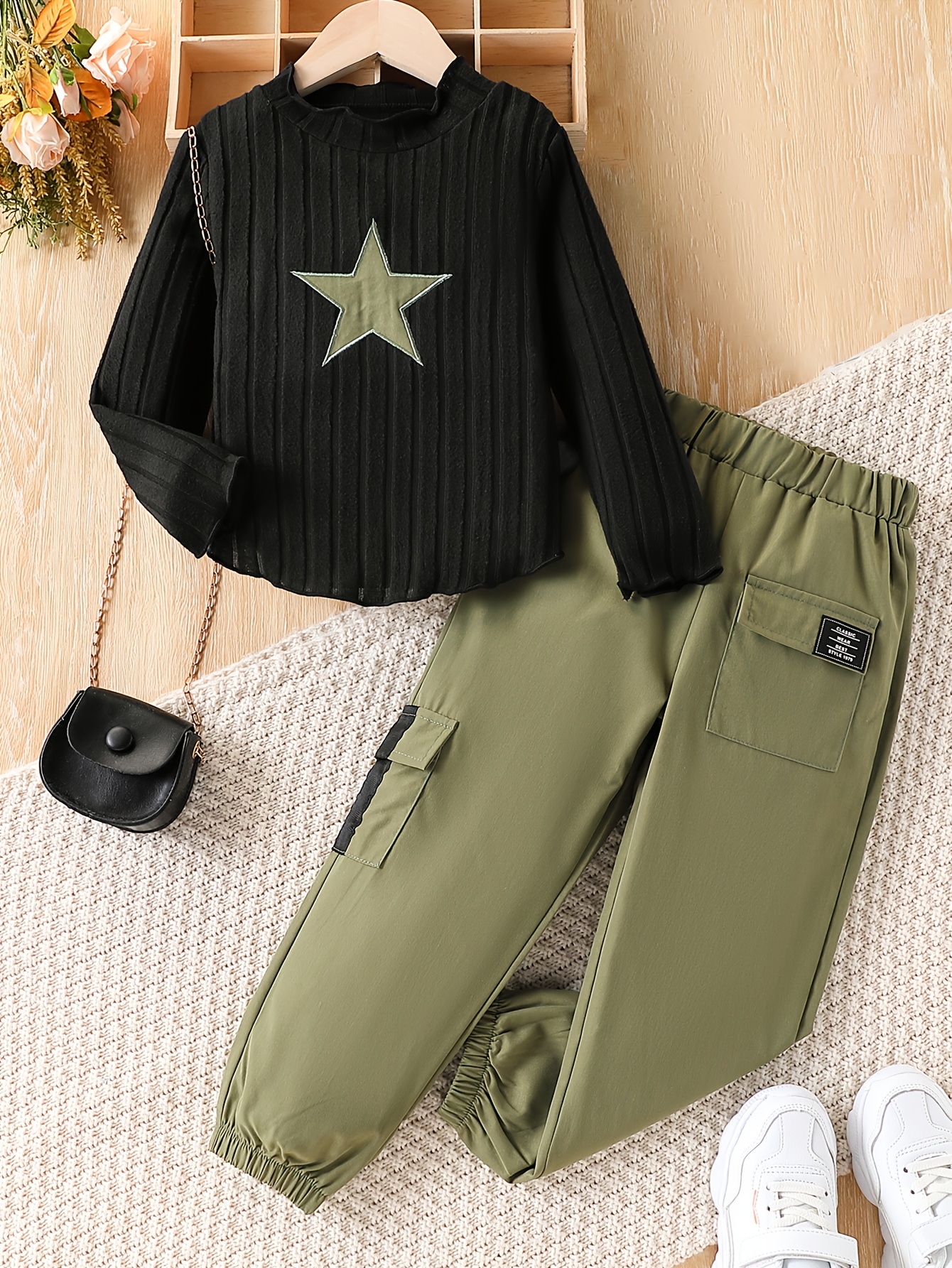 Adorable girls outfit featuring an embroidered star top and matching cargo pants perfect for spring or fall Made from comfortable medium stretch polyester