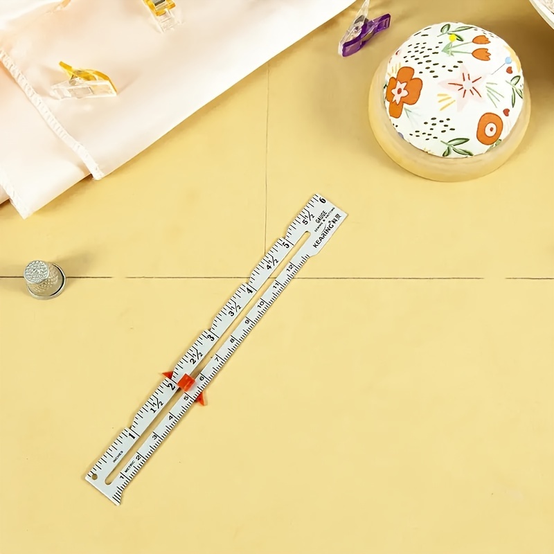 A Golden Sewing Gauge For Precise Measurements Of Fabrics, Hems, And Sewing Projects