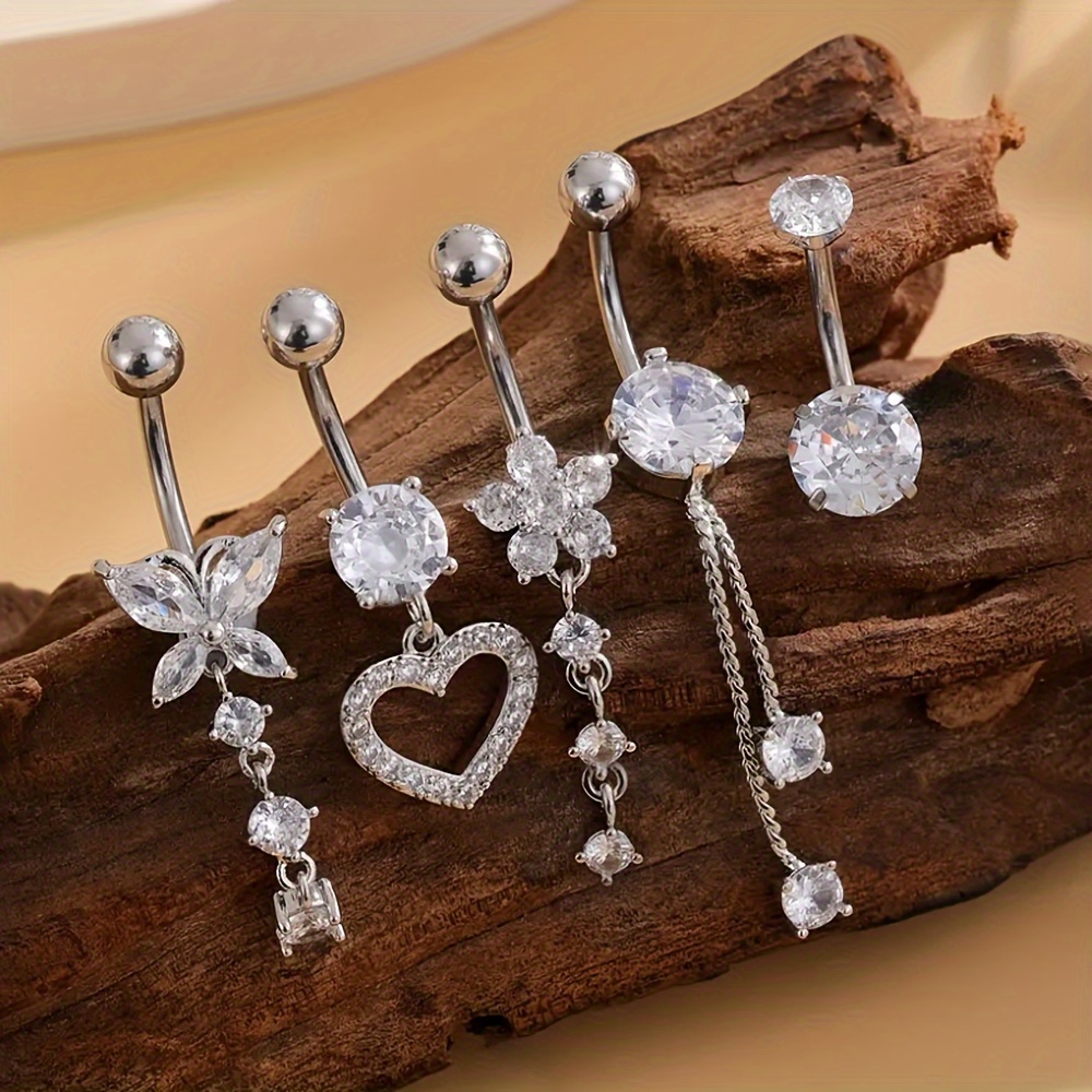 

A Set Of 5 Belly Button Rings With Copper And Zirconia, Featuring Butterfly, Flower, And Chain Designs, Perfect For Daily Wear, Holidays, Or As A Gift.